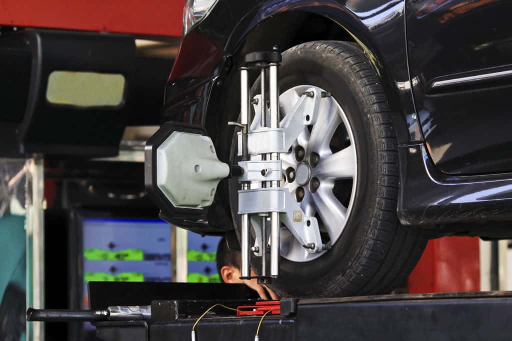 Car wheel fixed with computerized wheel alignment machine clamp.